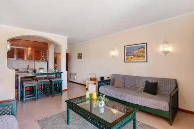 a living room with a couch and a table at Bela Vista House T2 in Albufeira