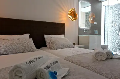 a bedroom with two beds with towels on them at Villa Pinheiro CD 84 - Cleverdetails in Vilamoura