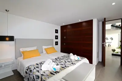 a bedroom with a bed with shoes on it at Villa Pinheiro CD 84 - Cleverdetails in Vilamoura
