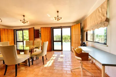 a dining room with a table and chairs at Casa Tranquility with beautiful heated pool and Jacuzzi! in Loulé