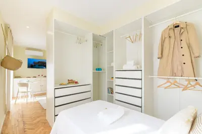 a bedroom with a white closet with a dresser at Urban Bliss Guesthouse II in Faro