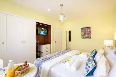 a bedroom with a bed with a tray of food on it at Urban Bliss Guesthouse II in Faro