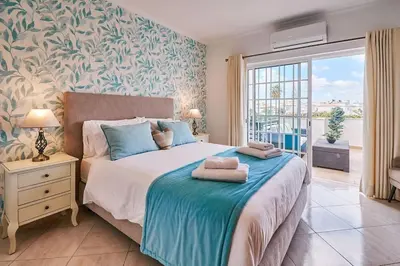 a bedroom with a bed with a blue and white patterned wall at Apartment O Monte mit Pool in Guia