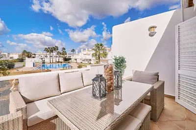 a patio with a couch and a table on a balcony at Apartment O Monte mit Pool in Guia