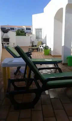 a pair of chairs and a table on a patio at Villa Quica, heated pool in Albufeira