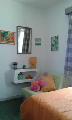 a room with a couch with a teddy bear on it at Villa Quica, heated pool in Albufeira