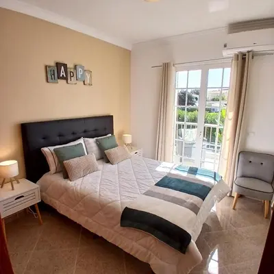 a bedroom with a bed with two towels on it at Villa Martinique in Albufeira
