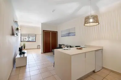 a kitchen and living room with a island in a room at Apartamento Sousa e Filhos in Albufeira