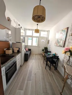 a kitchen with a table and a dining room at Grand Studio 31 in Faro