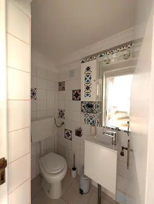 a bathroom with a toilet and a sink at Grand Studio 31 in Faro