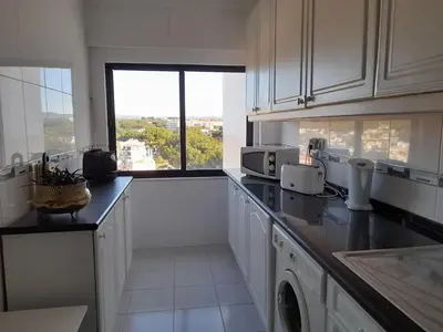 a woman taking a picture of a bathroom sink at Modern apartment in Vilamoura with shared pool in Vilamoura