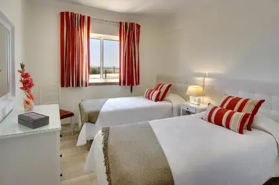 a hotel room with two beds and a window at Inn The Beach Apartments by Seareen in Albufeira