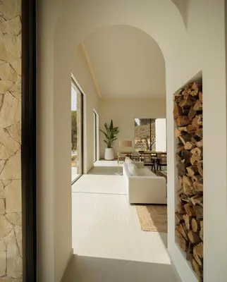 a living room with a white couch and a fireplace at Luxury Villa In Quinta do Lago Private pool Rooftop Jacuzzi Office Game room ARKEO LUXURY in Almancil