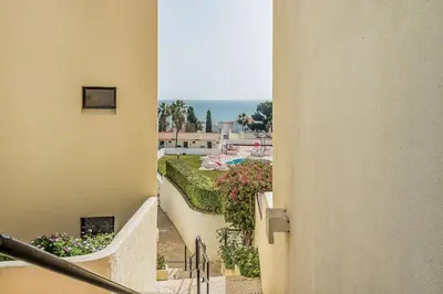 a view of a balcony of a building with flowers at Studio avec vue mer et piscine Algarve Portugal in Albufeira