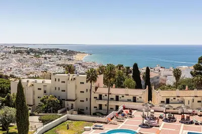 a view of a city and the ocean from a resort at Studio avec vue mer et piscine Algarve Portugal in Albufeira