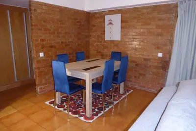 a dining room with a table and blue chairs at Casa do Cedro in Albufeira