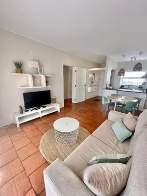 a living room with a couch and a tv at Solar Home appartement T2 in Albufeira