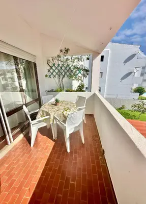 a patio with a table and chairs on a balcony at Solar Home appartement T2 in Albufeira
