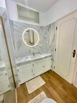 a bathroom with a white sink and a mirror at Solar Home appartement T2 in Albufeira