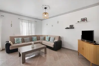 a kitchen with a sink and a table with a bowl of fruit on it at Villa Martina in Albufeira