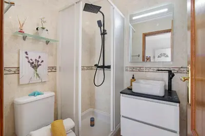 a bedroom with a bed and a desk and a mirror at Villa Martina in Albufeira