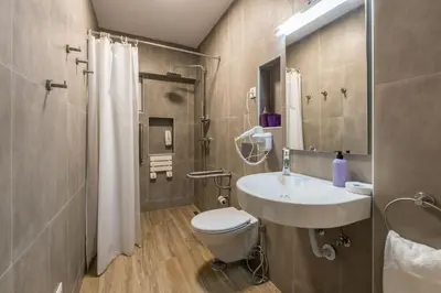a bathroom with a sink and a toilet and a shower at LovelyStay - Green Oasis Villa in Vilamoura