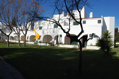 a white building with trees in front of it at LovelyStay - Green Oasis Villa in Vilamoura