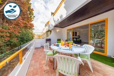 a table and chairs on the balcony of a house at Apartment Portofino 1 by Algarve Vacation in Vilamoura