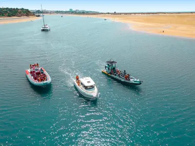 three boats in a body of water next to a beach at Apartment Portofino 1 by Algarve Vacation in Vilamoura