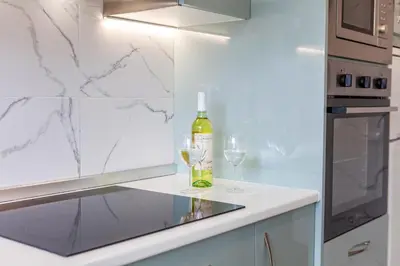 a kitchen with white appliances and a window at Apartment Portofino 2 by Algarve Vacation in Quarteira