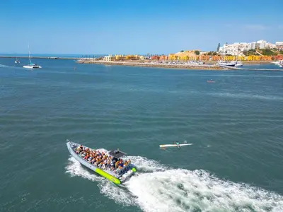 a group of people in a boat in the water at Apartment Portofino 2 by Algarve Vacation in Quarteira