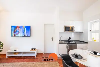 a bedroom with a bed and a tv on the wall at #062 Villa Lemon 3 by Home Holidays in Albufeira