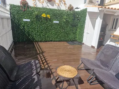 a patio with a table and chairs and a fireplace at RECANTO da FELICIDADE in Albufeira