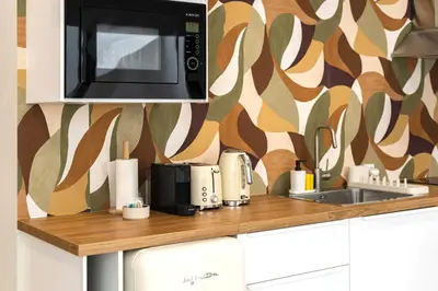 a counter top with a microwave and a toaster at Villa 41 - Private Studios Faro Airport, Beach and City Center in Faro