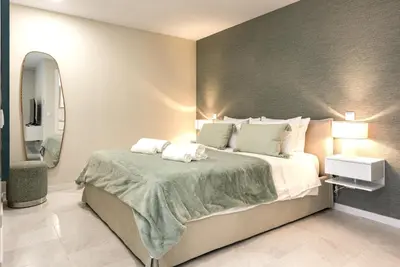 a hotel room with two towels on a bed at Villa 41 - Private Studios Faro Airport, Beach and City Center in Faro