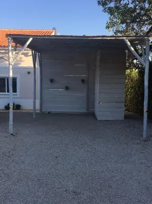 a white garage with a roof on top of it at Casa Herdeiro in Faro