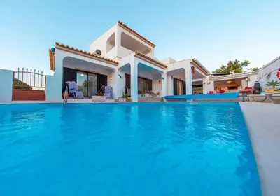 a villa with a swimming pool in front of a house at Villa Thai by Algarve Vacation in Albufeira