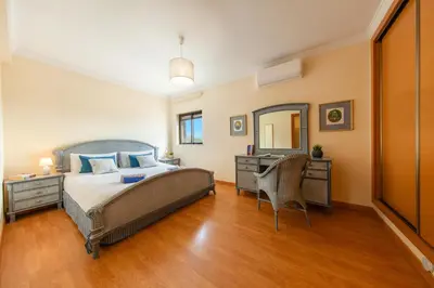 a bedroom with a bed and a desk and a mirror at Villa Thai by Algarve Vacation in Albufeira