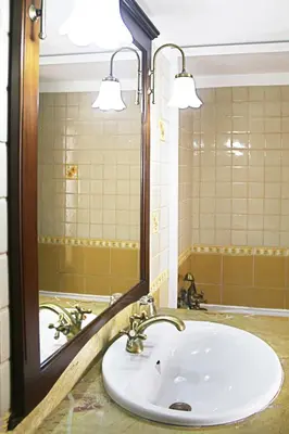 a bathroom with a sink and a mirror at Monte dos Avós in Querença