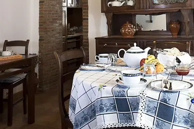 a table with a blue and white table cloth on it at Monte dos Avós in Querença