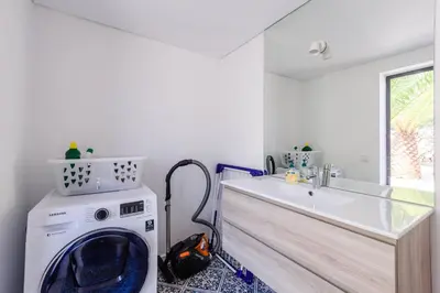 a laundry room with a washing machine and a sink at Casa dos Sonhos, Vale do Lobo in Almancil