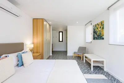 a bedroom with a white bed and a desk at Casa dos Sonhos, Vale do Lobo in Almancil