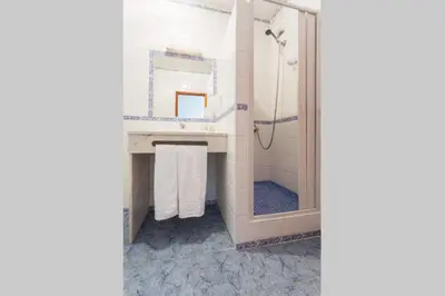 a bathroom with a shower and a sink at Residencial Capri by Umbral in Albufeira