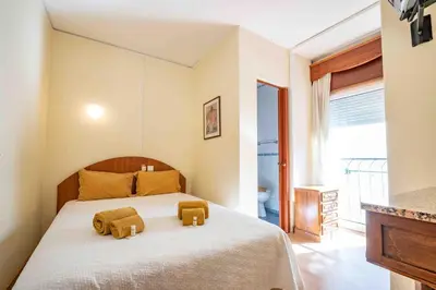 a bedroom with a bed with two towels on it at Residencial Capri by Umbral in Albufeira