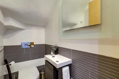 a bathroom with a sink and a toilet at Casa Maguy in Albufeira