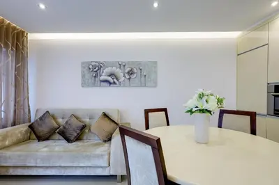 a living room with a table and a couch at Casa Maguy in Albufeira
