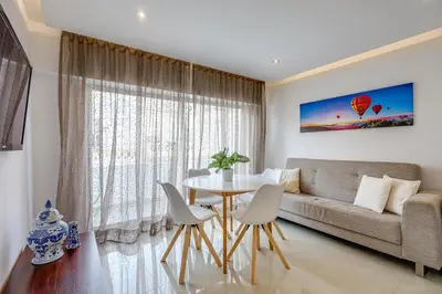 a living room with a couch and a table at Casa Maguy in Albufeira