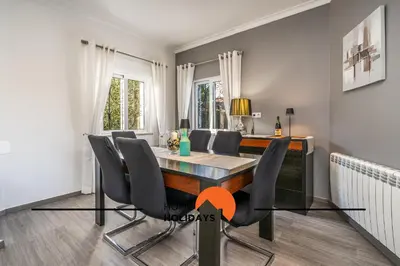 a dining room with a table and chairs at #239 Vivenda V3 com Piscina by Home Holidays in Albufeira