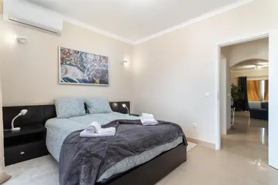 a bedroom with a large bed with towels on it at Host Wise - Bright Lovely Flat - Balcony in Guia