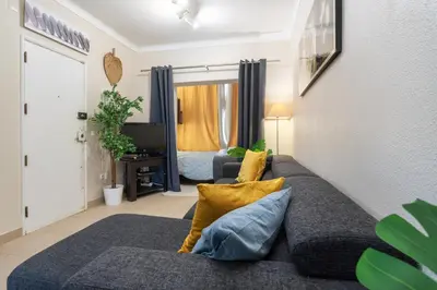 a living room with a couch and a bed at Host Wise - Bright Lovely Flat - Balcony in Guia